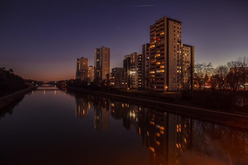 brown concrete building beside water