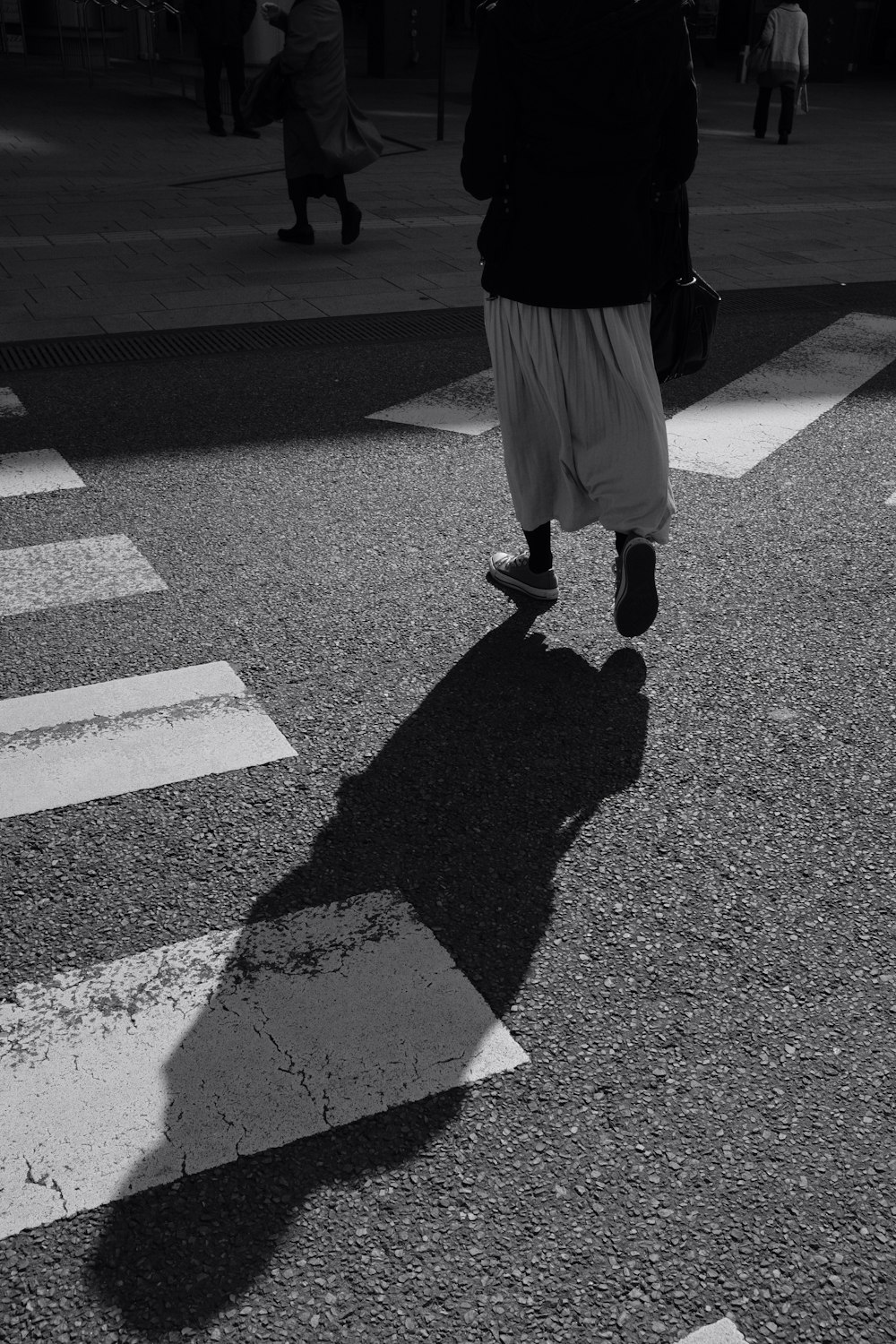 person walking at road during daytime