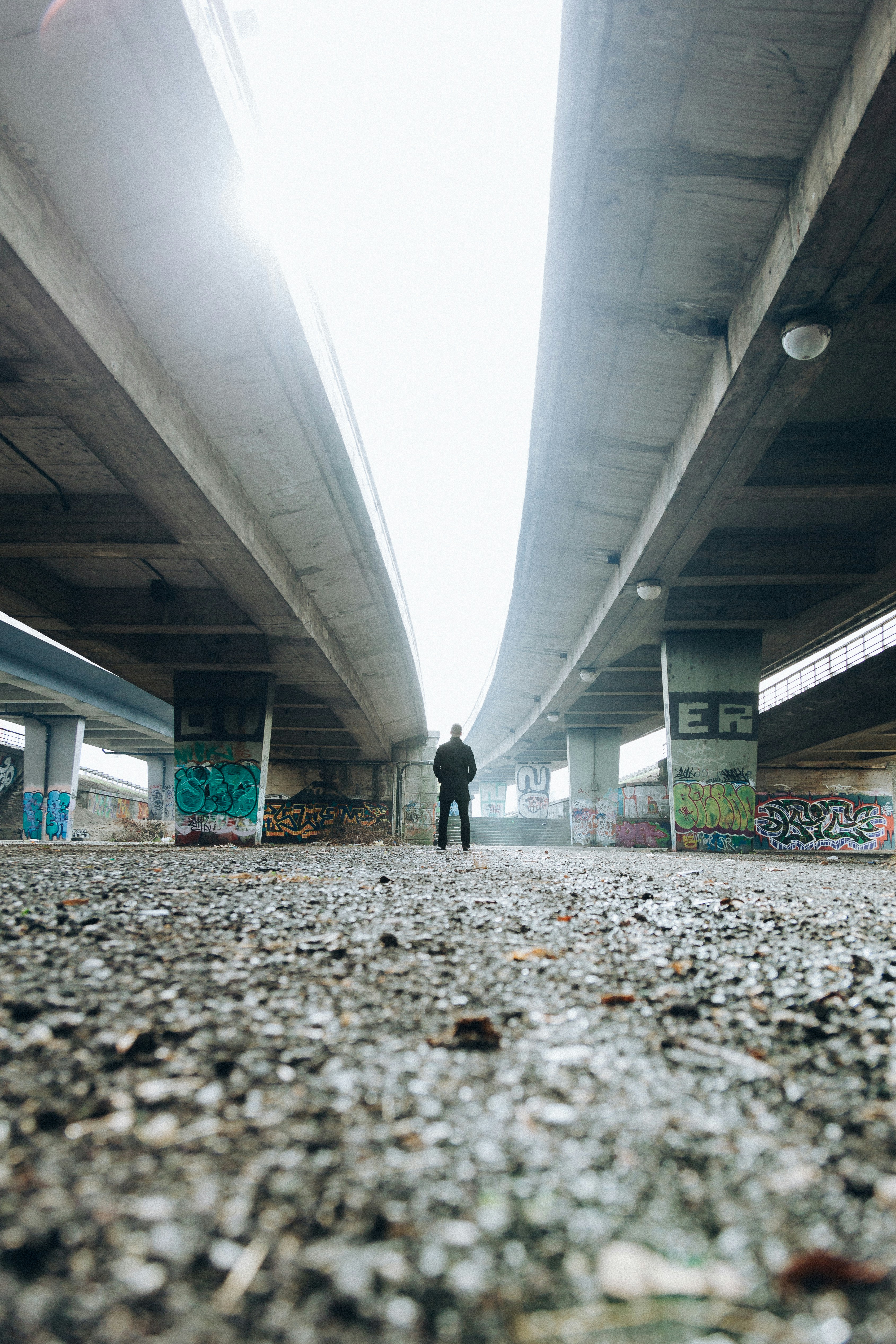 man standing under the bridge