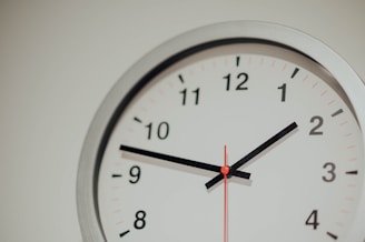 round silver analog wall clock displaying 1:48 time