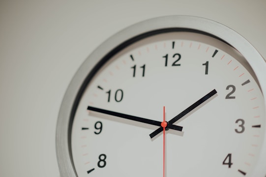 round silver analog wall clock displaying 1:48 time