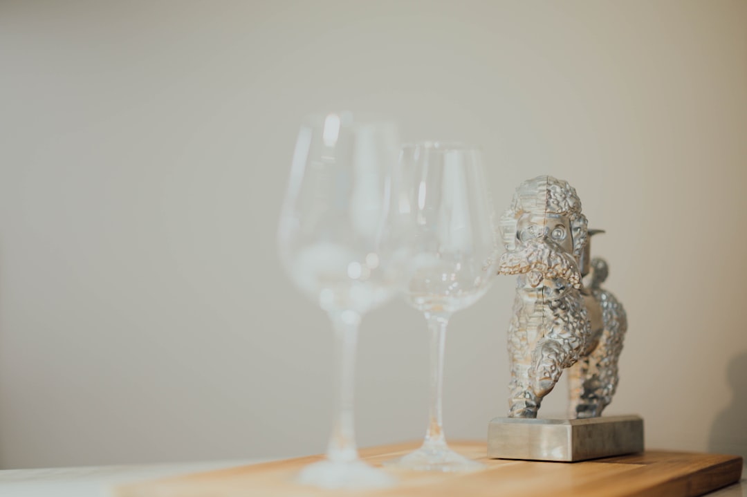 selective focus photography of long stem wine glasses on table