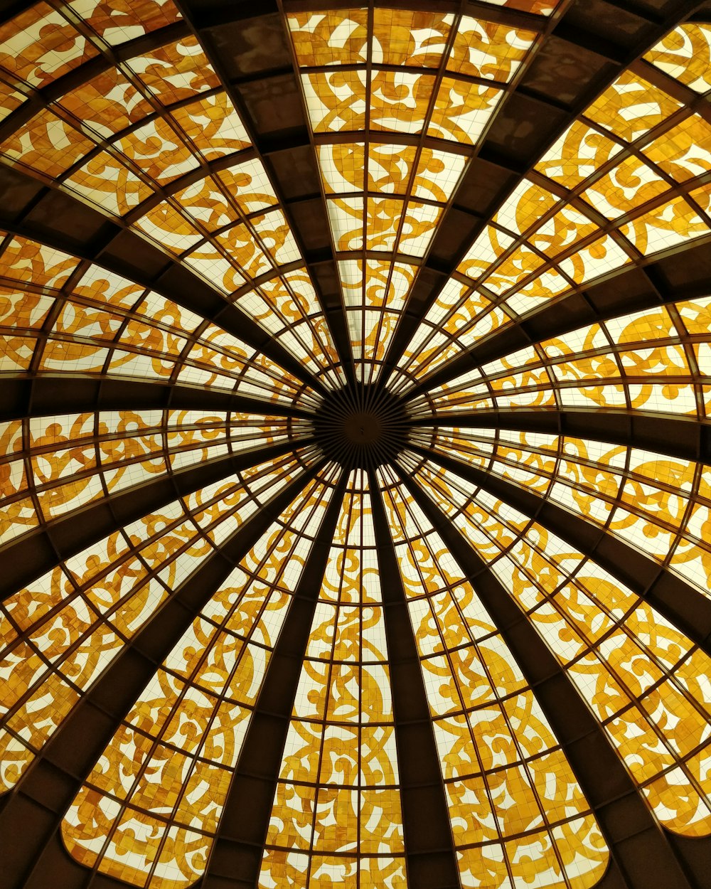 a glass ceiling with a circular design in it