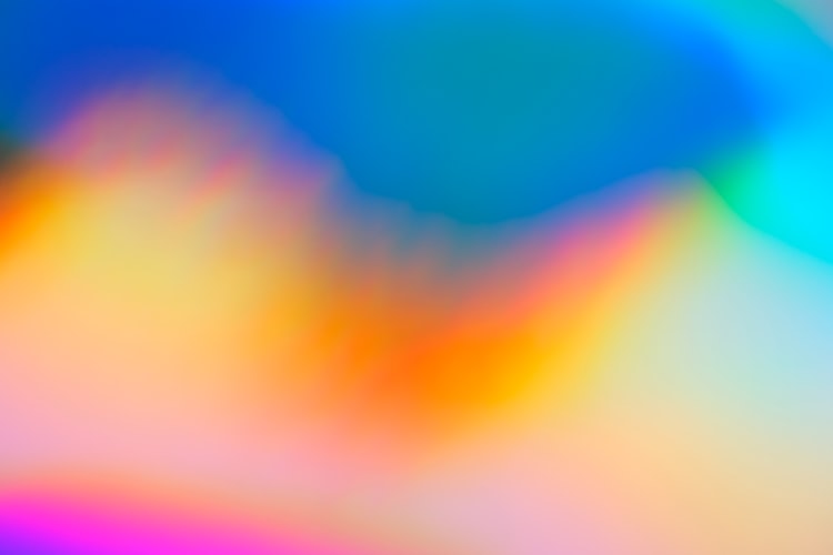 Abstract image with soft yellow, pink, and blue shapes