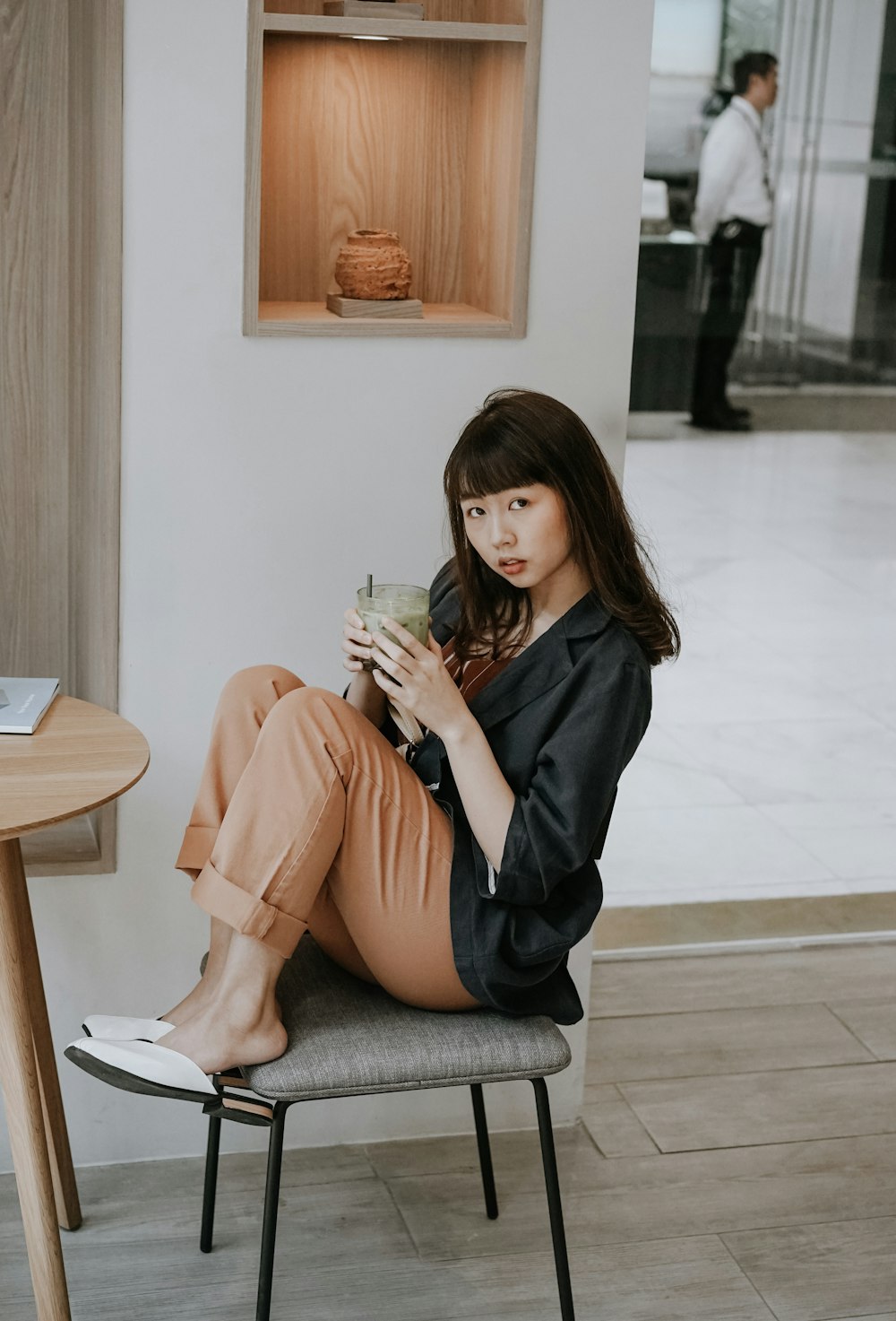 woman in black coat sitting on chair