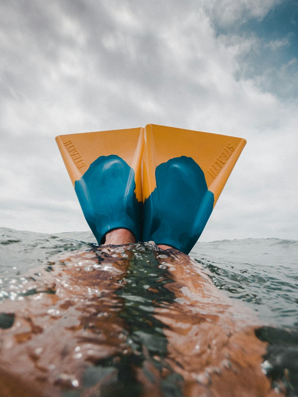 person under water wearing flippers