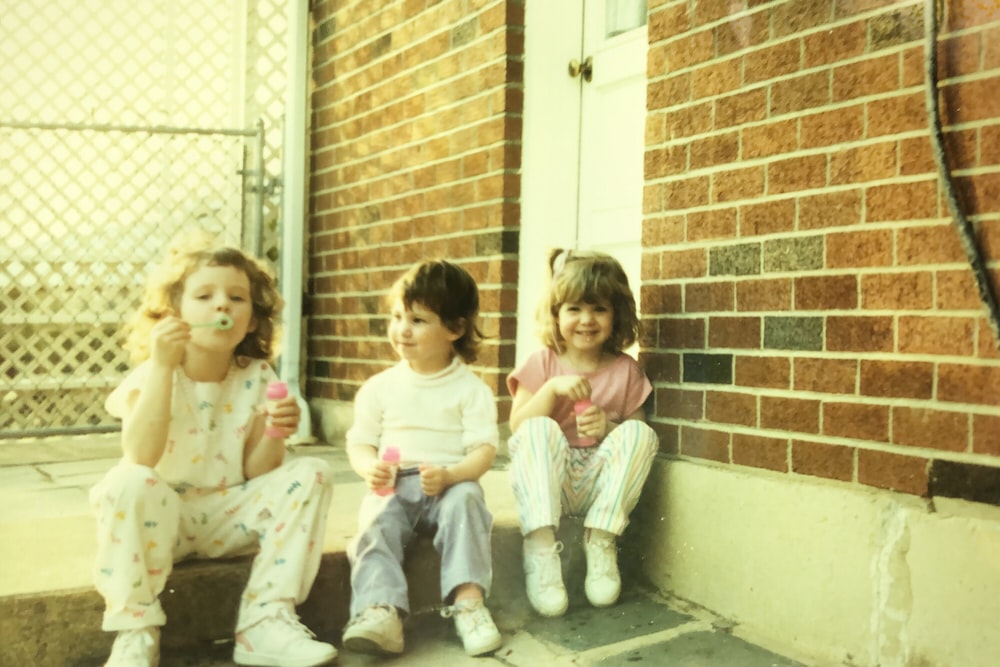 three toddlers playing balloon outdoor