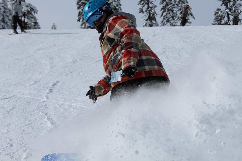 snowboarder on slope wearing blue helmet