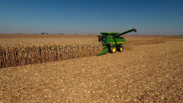 John Deere plow beside dried field