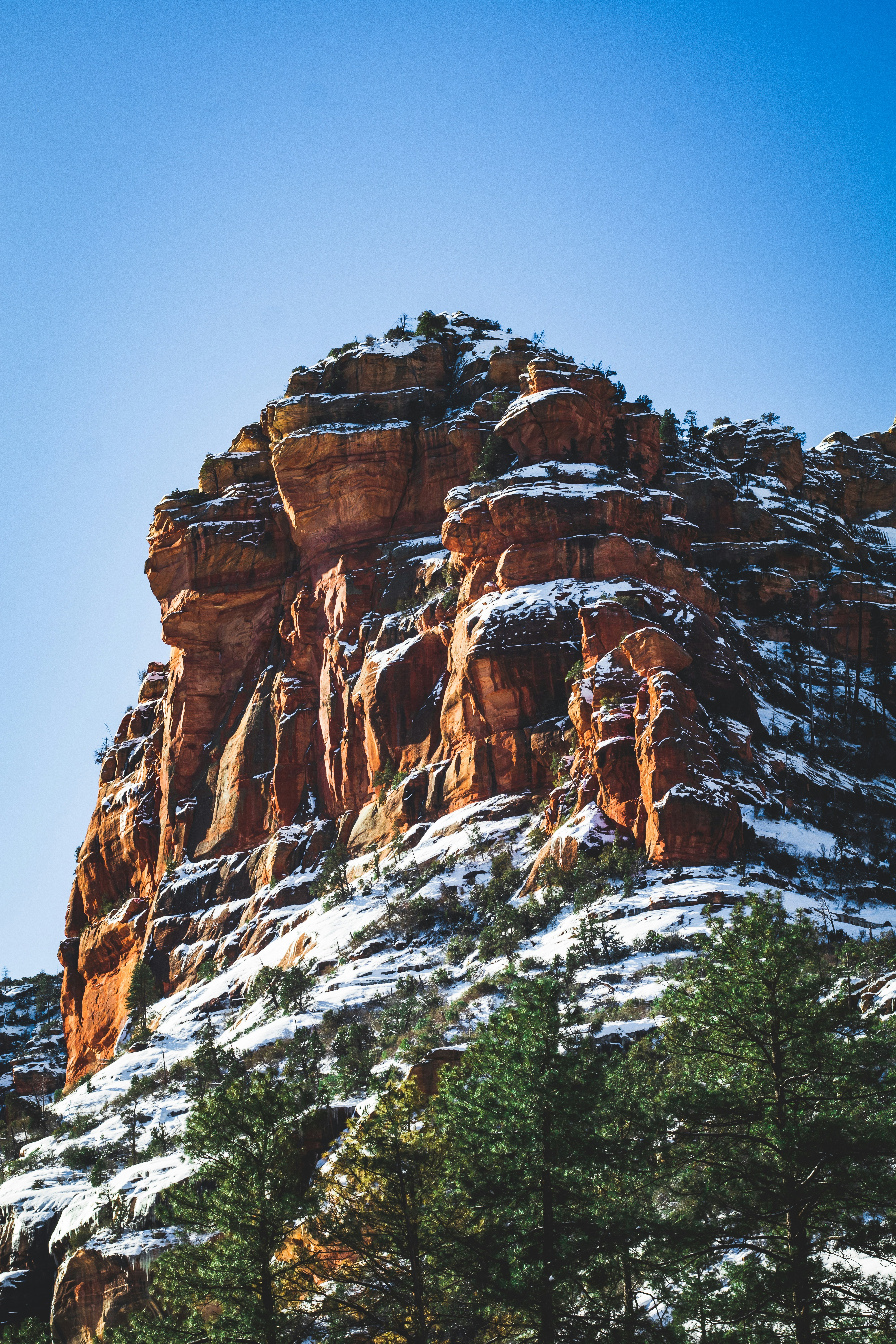 snow covered brown mountain during daytime