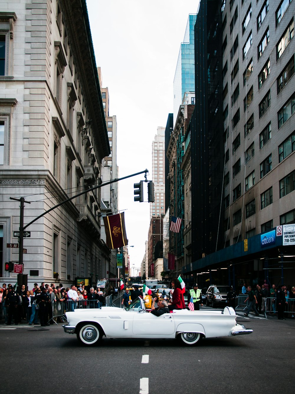 white car between buildings during daytime