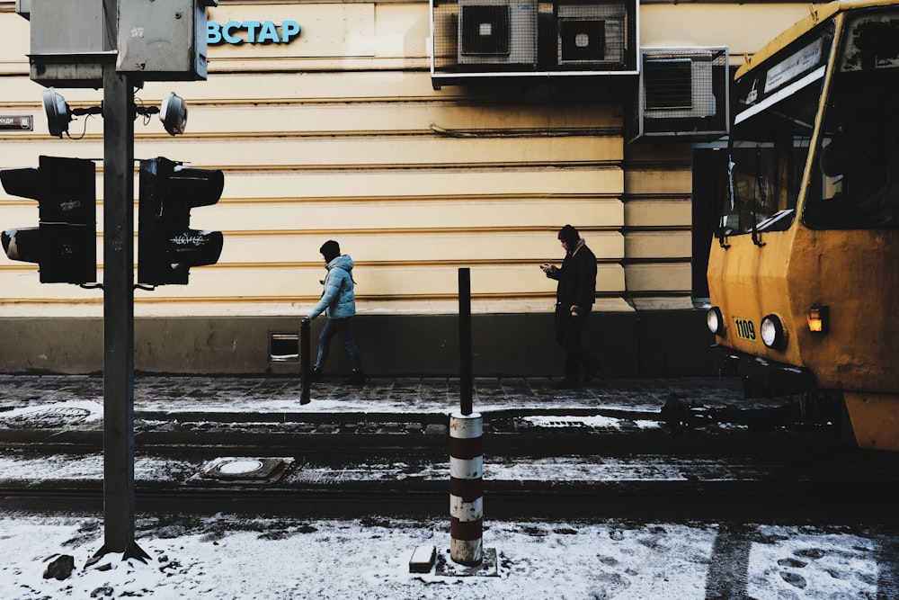 two person walking on sidewalk