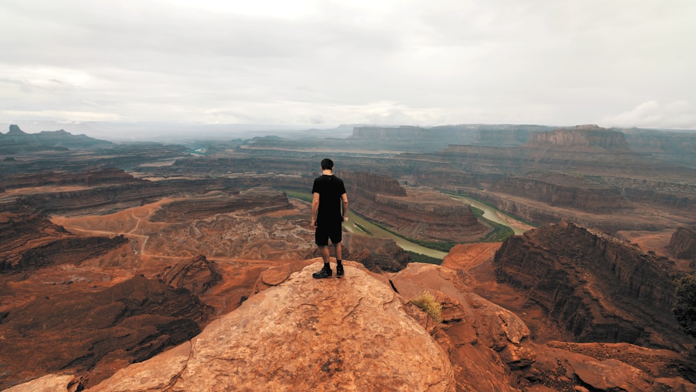 man standing on cliff