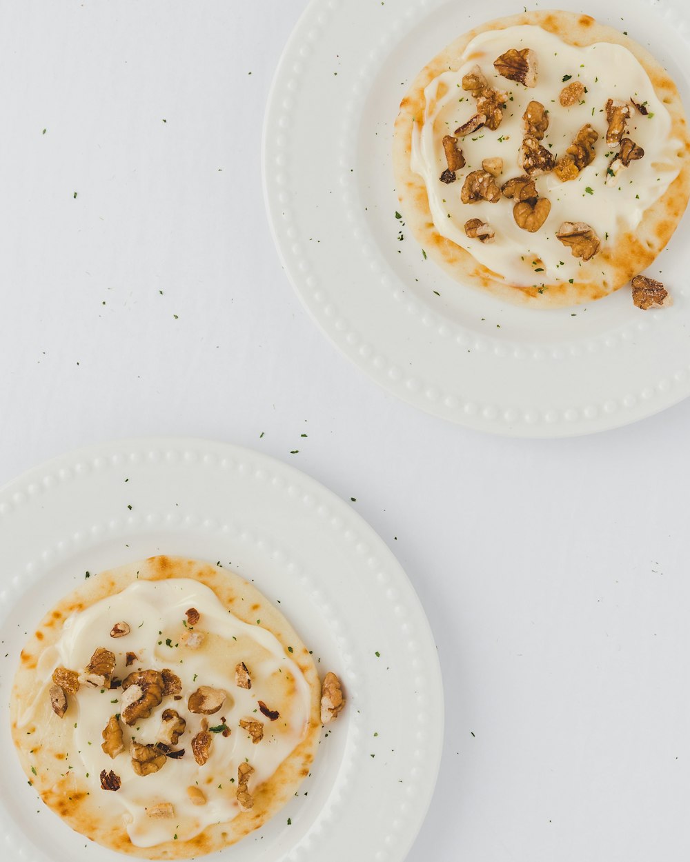 two sunny side up egg on white plates