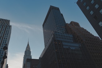 Modern architectural towers inspired by iconic global landmarks under a clear sky.