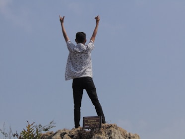 Happy person celebrating financial freedom after paying off debts.