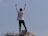 A happy person standing outdoors with arms raised, celebrating freedom from smoking.