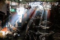 Sunlight casting shadows over a team collaborating to assemble complex machinery outdoors.