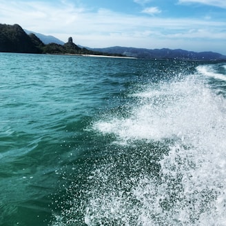 A scenic view of a fastboat cruising through turquoise waters near Bali.