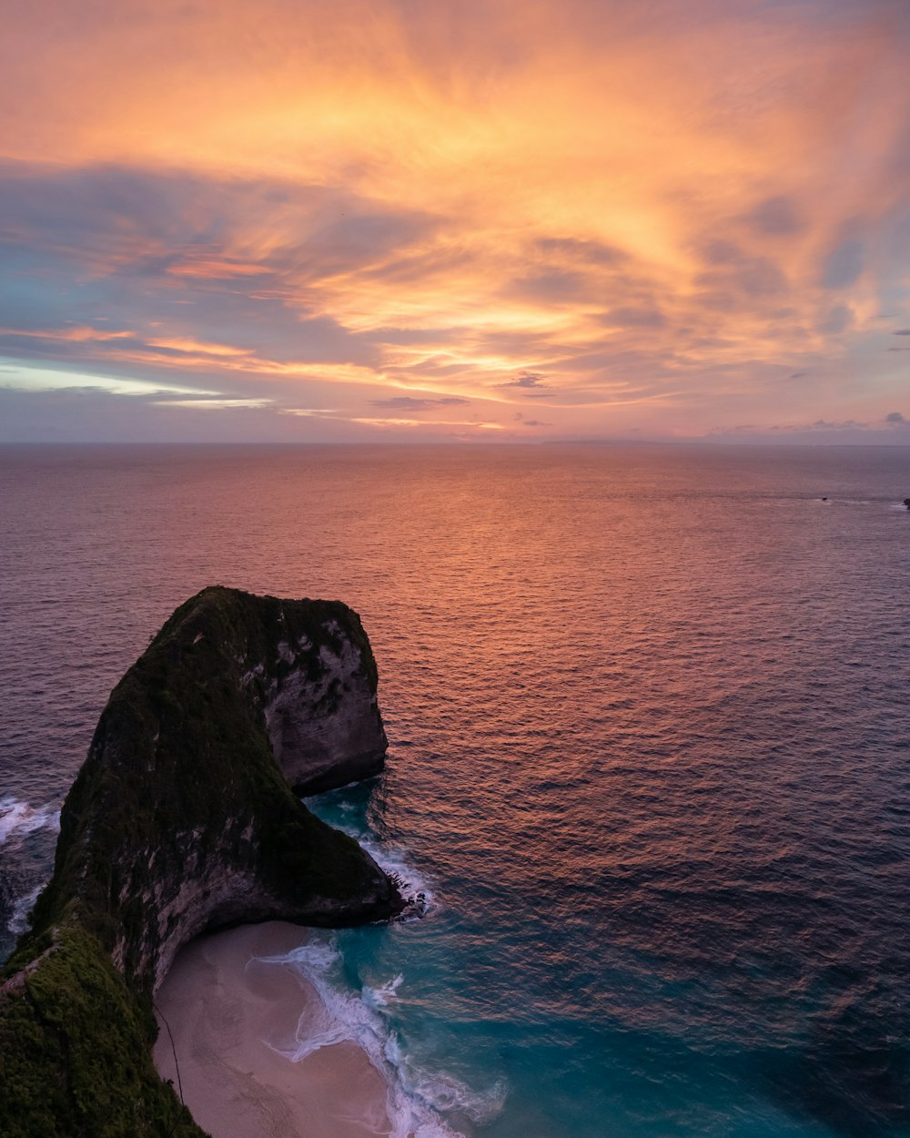 dinosaur-shaped island beside sea