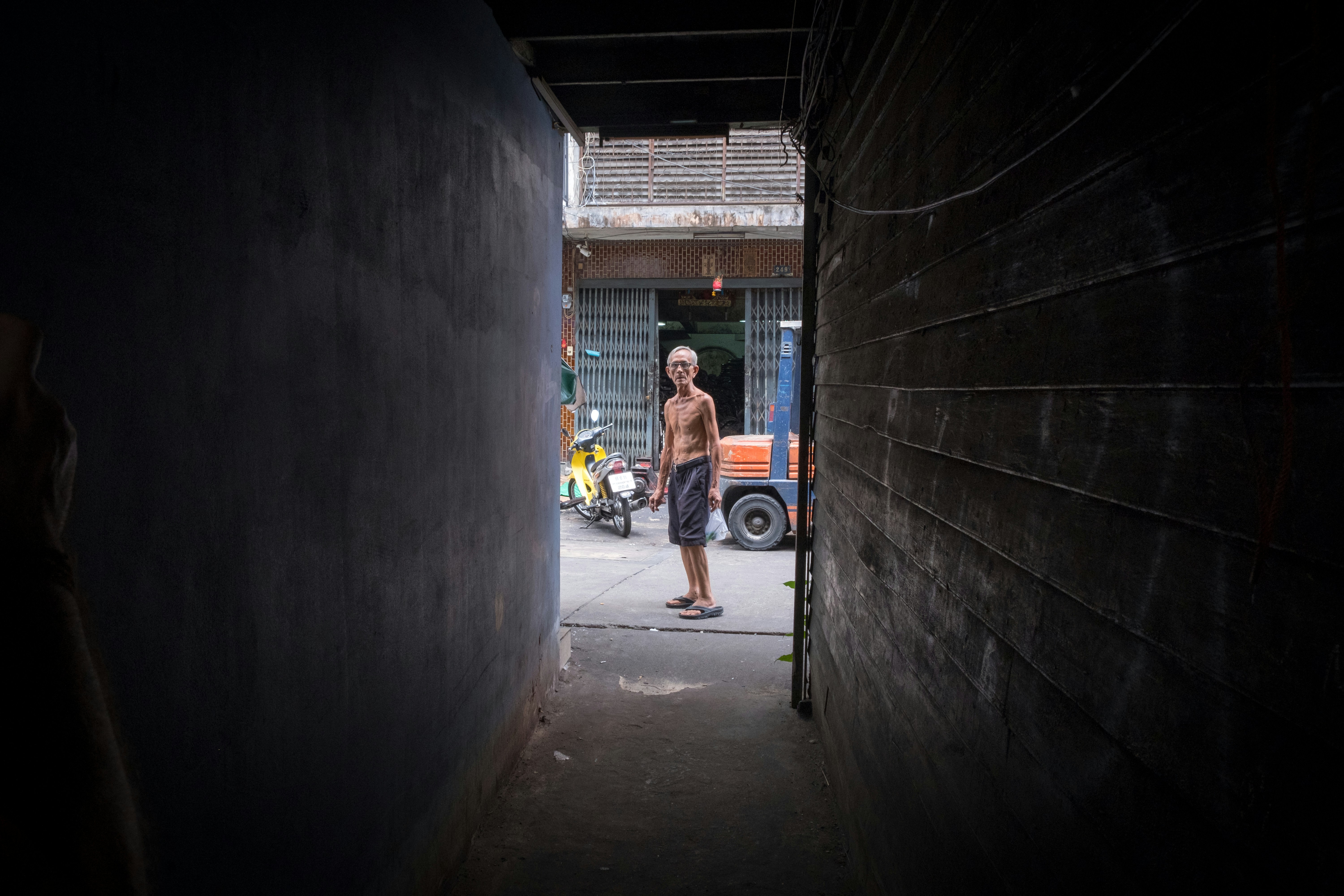 man standing on road