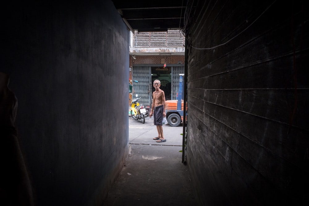 man standing on road