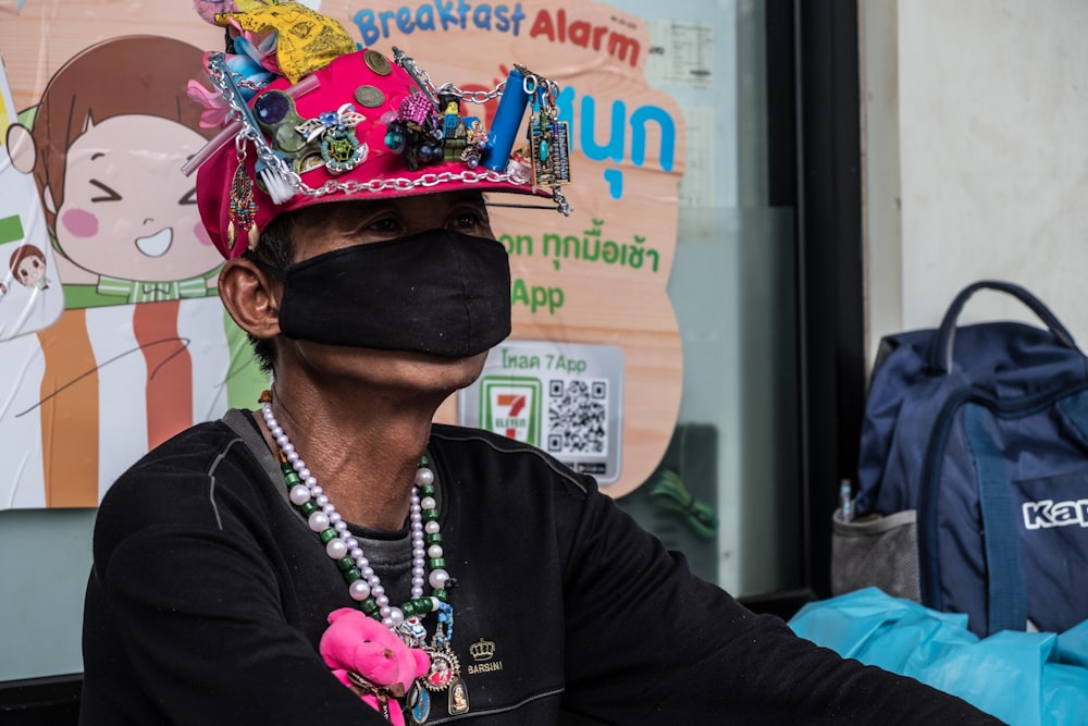 man sitting while wearing mask