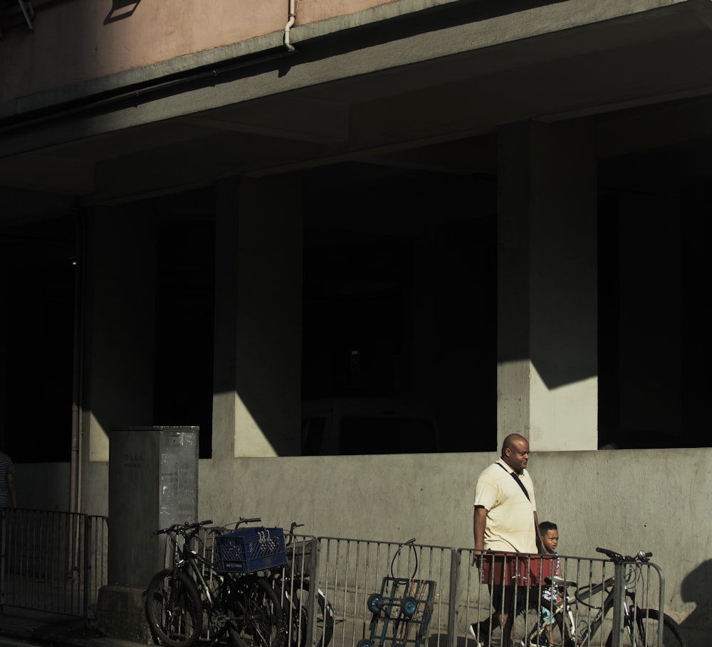 man and boy walking beside building