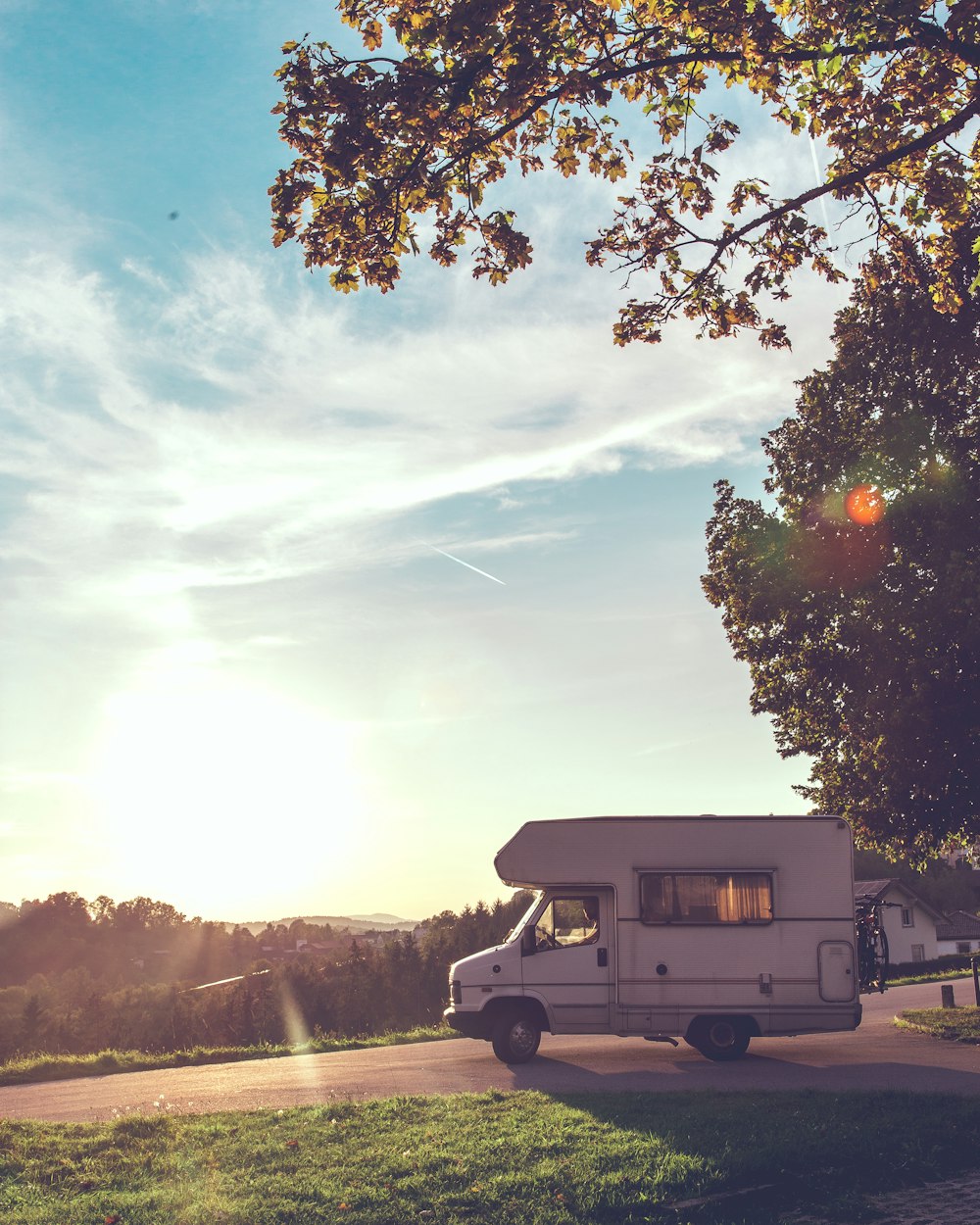 white RV truck across green woods