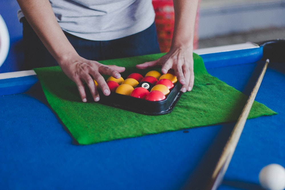 man fixing billiard balls