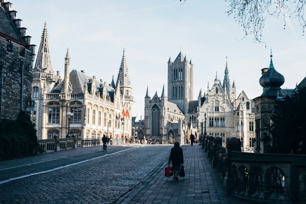 Person walking and holding two bags — Ghent, Belgium