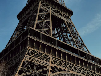 Close-up of the intricate architecture on the Cairo Tower against a clear blue sky.