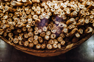 Braided bully sticks displayed in a basket with natural lighting highlighting their texture