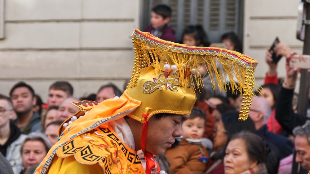 shallow focus photo of man wearing yellow headdress