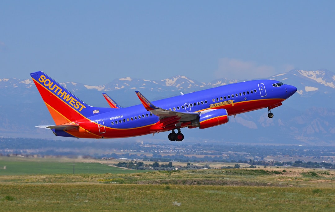 blue and red Southwest passenger airline in flight, Denver Airport. August 2011.<p></figure>Visit at Denver during personal aviation US tour 2011.