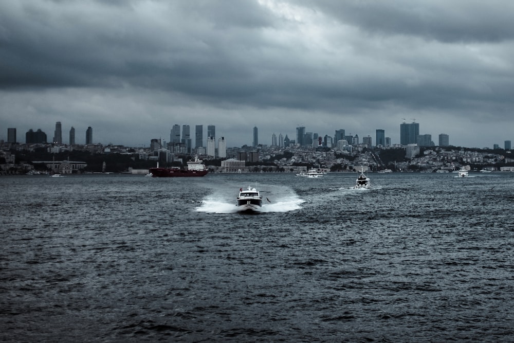 white speed boat at middle of sea