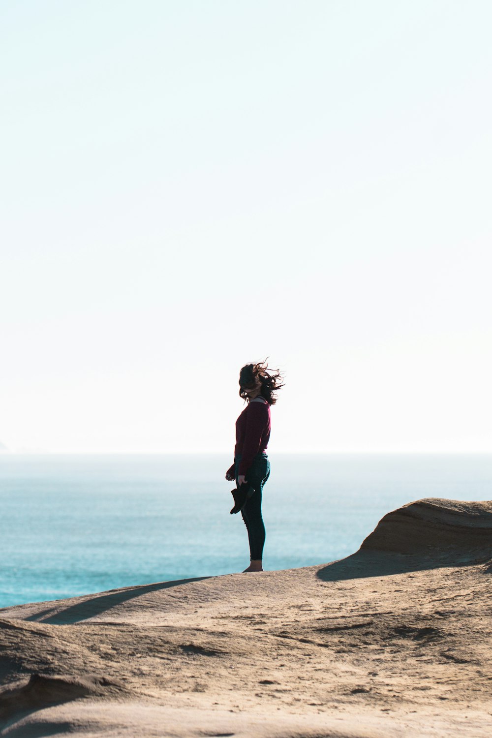 woman standing near body of water