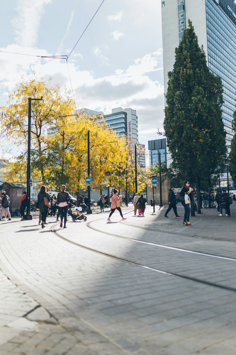 people walking beside concrete building