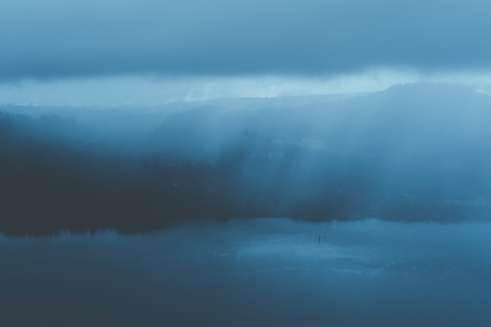 a large body of water under a cloudy sky