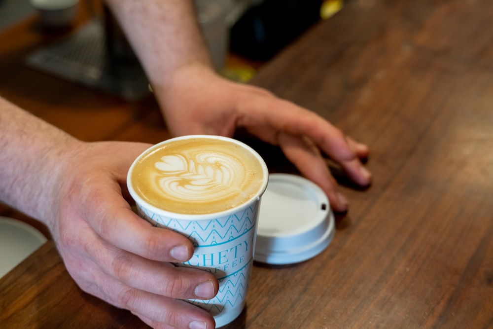 persona che tiene la tazza di caffè