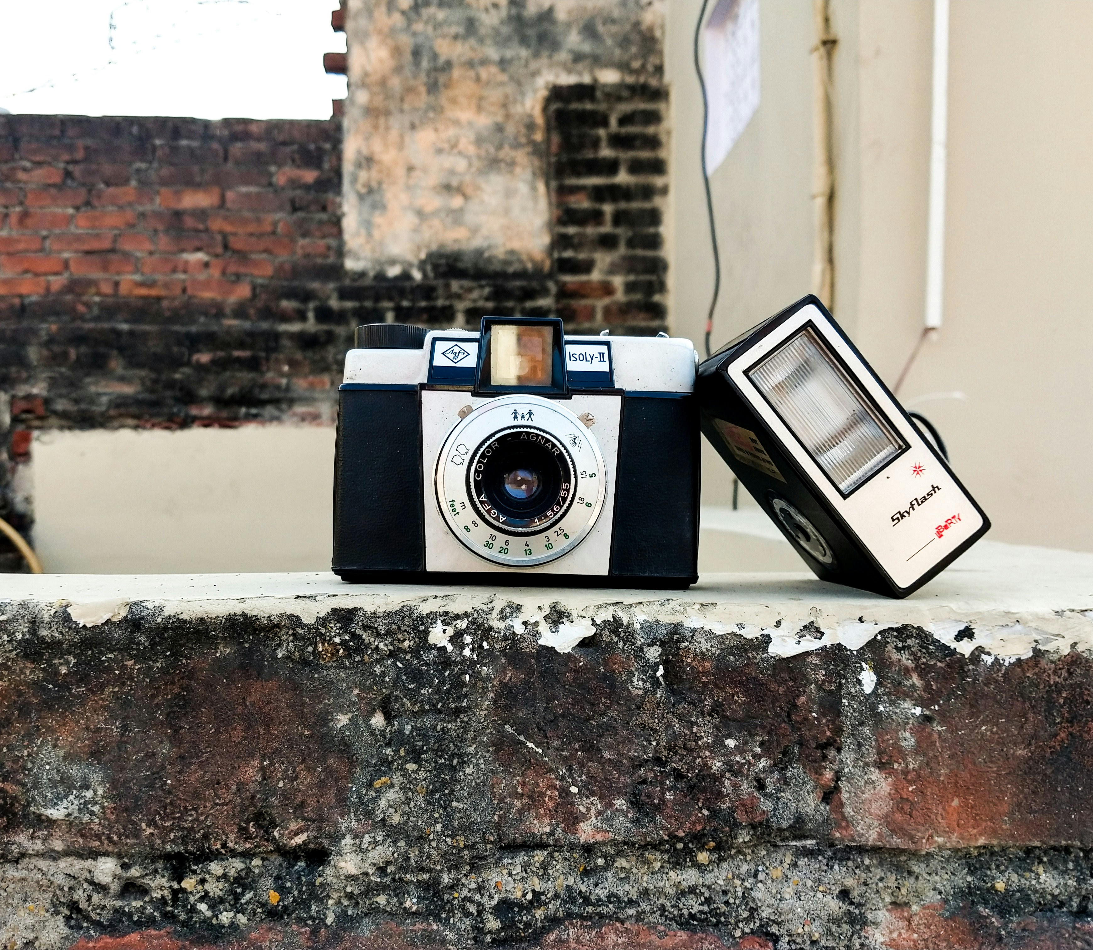 Gray camera on brick wall photo Free Grey Image on Unsplash