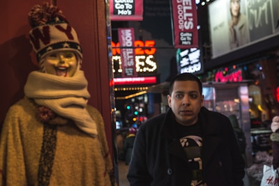 Nighttime street scene showing a model wearing layered apparel with geometric cuts and subtle LED accents.