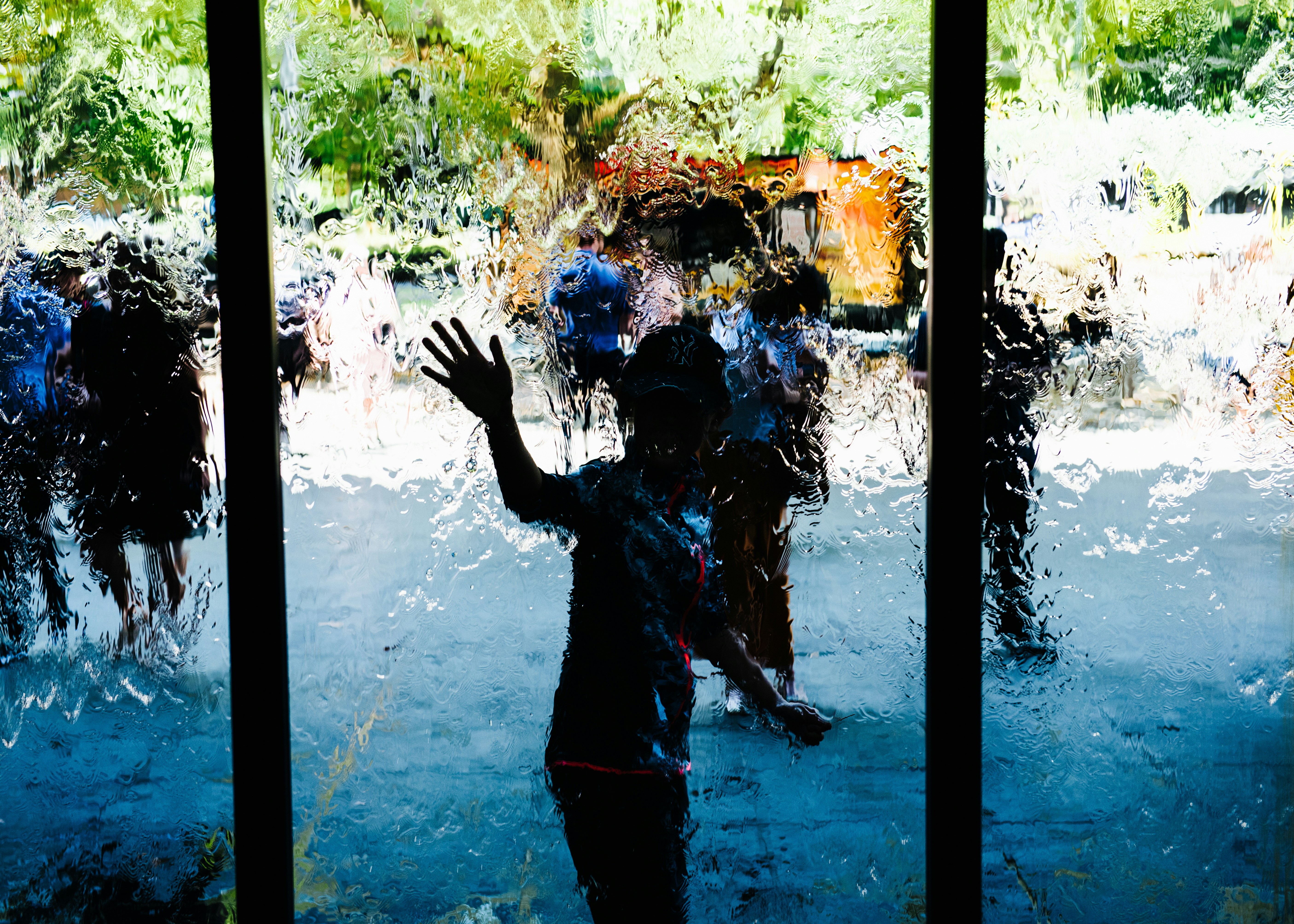 Boy standing in front of glass
