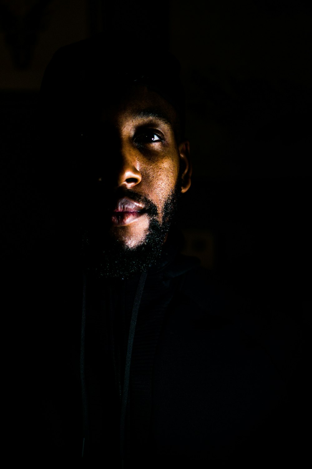 a man with a beard in the dark
