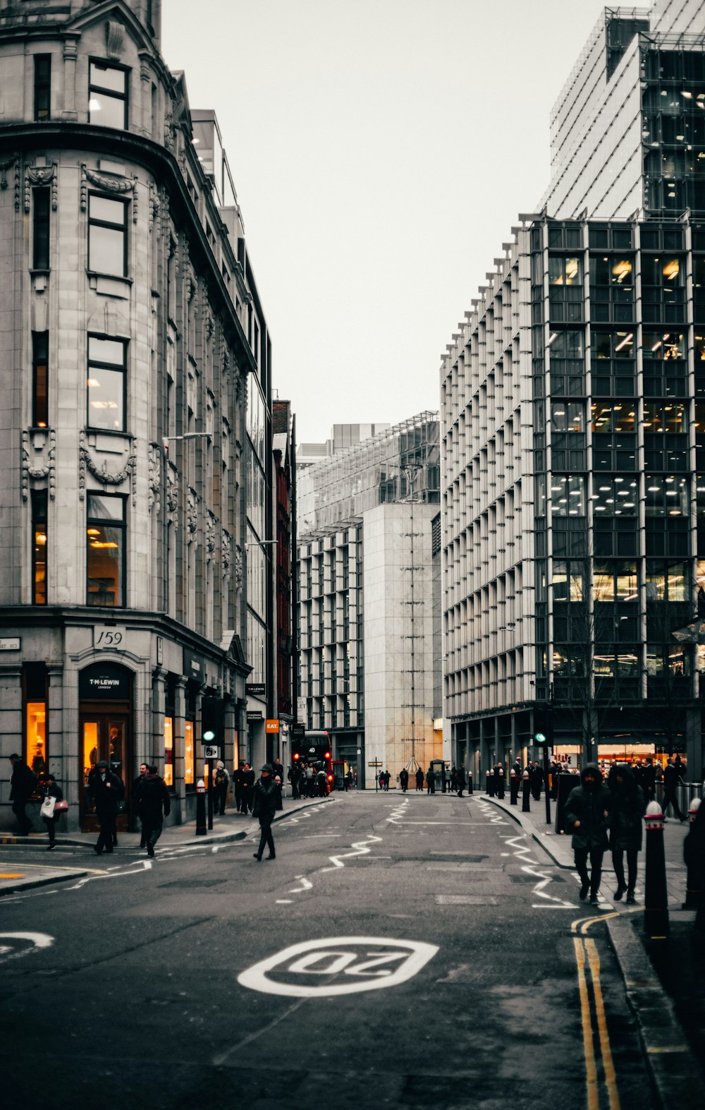 single perspective photography of people walking between buildings