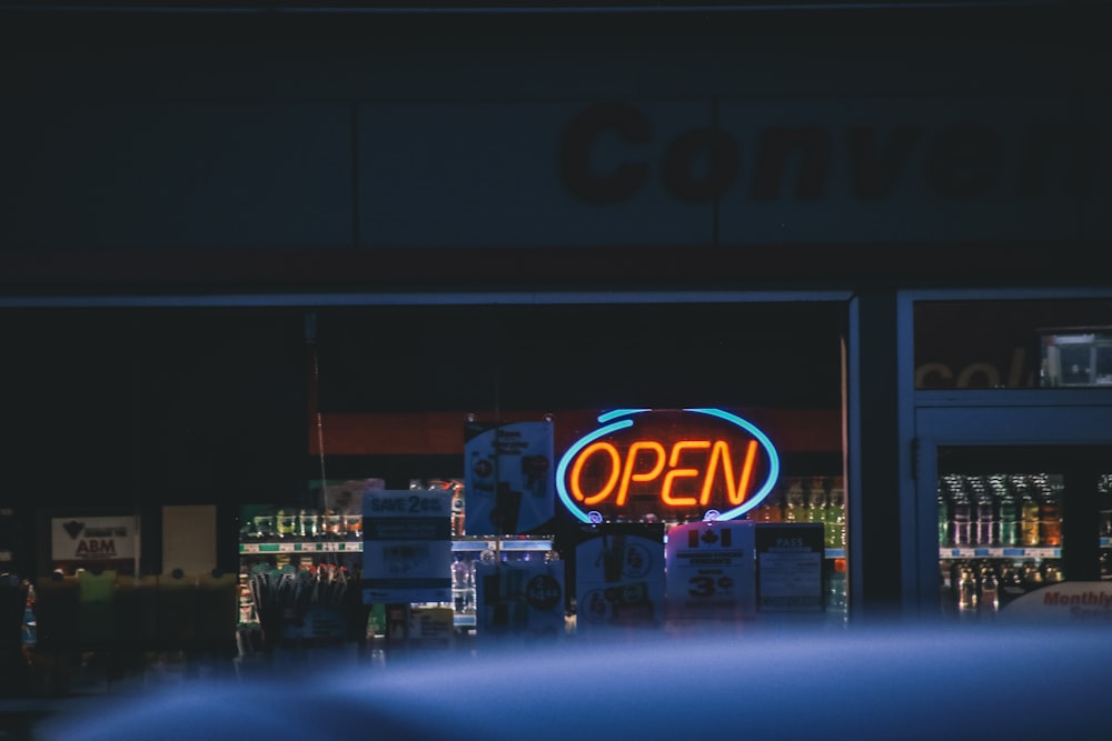 turned on red and blue OPEN neon signage