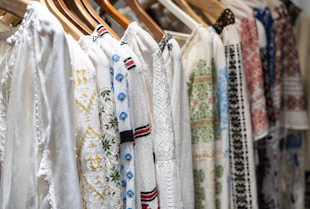 Close-up of a finely stitched Argentine fabric shirt hanging on a rack.