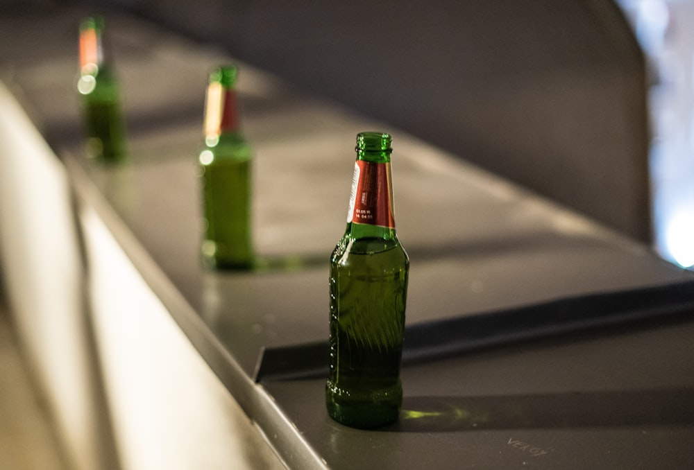 green glass bottle on table