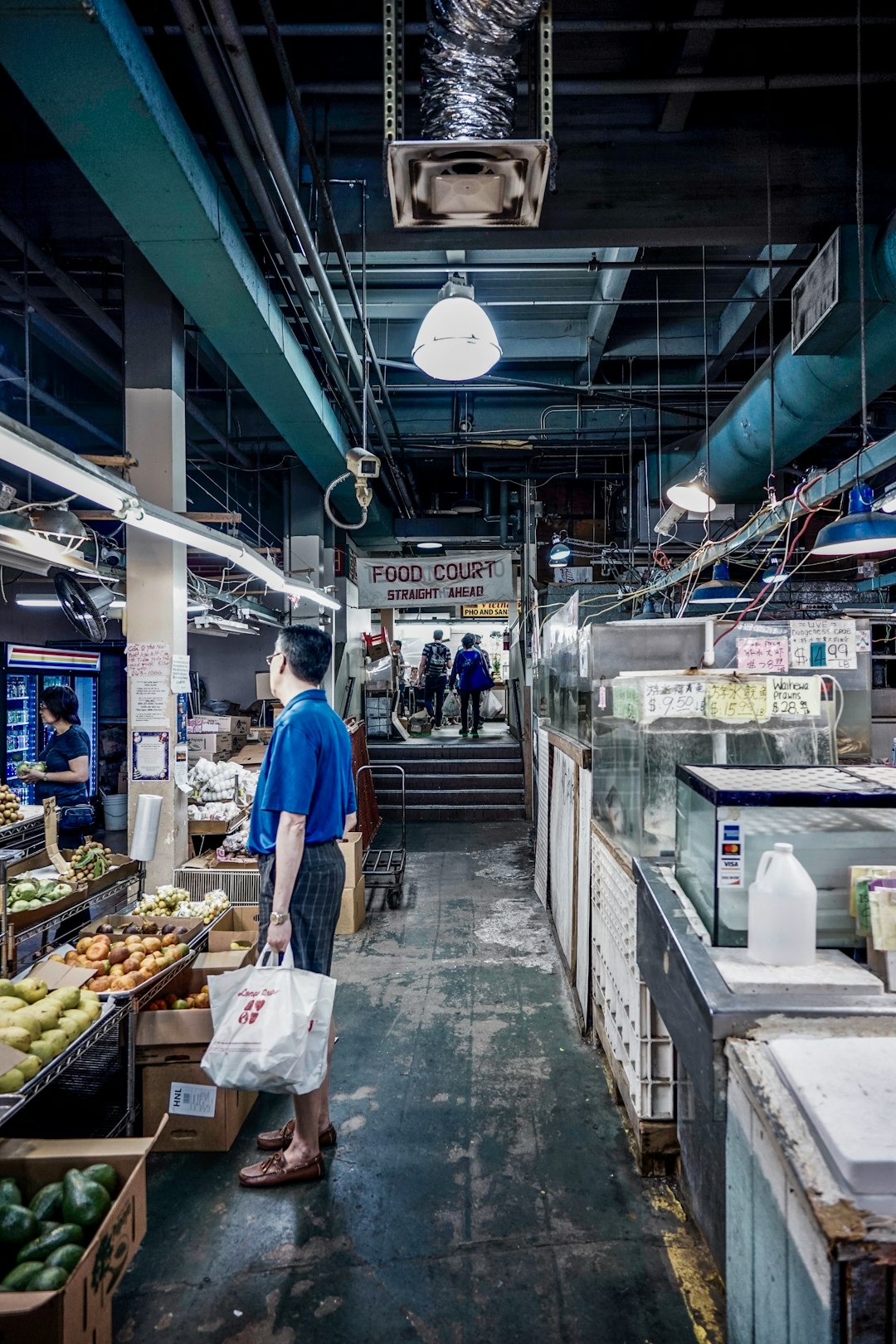 man holding shopping bag in food court