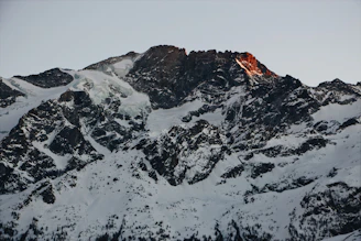 A rugged mountain peak at dawn symbolizing strength and endurance.